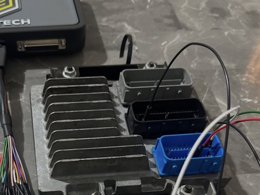A vehicle ECU connected to a Haltech tuning device